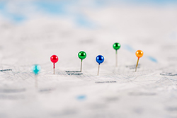 Colorful pins on a blurry map showing people choosing an Ortley Beach vacation rental.